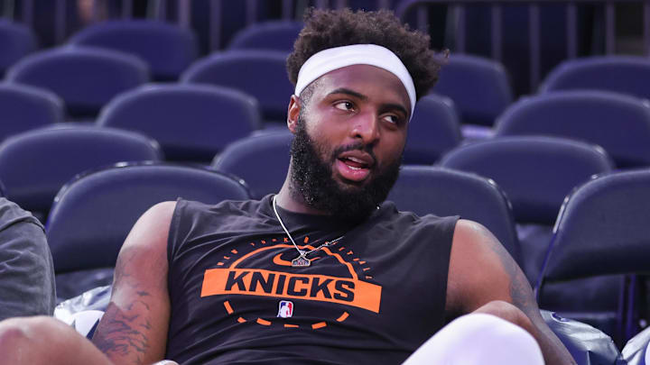 Nov 9, 2025; New York, New York, USA;  New York Knicks center Mitchell Robinson (23) sits courtside during pregame warmups prior to the game against the Brooklyn Nets at Madison Square Garden. Mandatory Credit: Wendell Cruz-Imagn Images