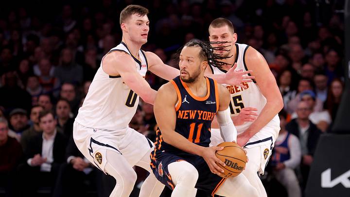Jan 29, 2025; New York, New York, USA; New York Knicks guard Jalen Brunson (11) controls the ball against Denver Nuggets guard Christian Braun (0) and center Nikola Jokic (15) during the fourth quarter at Madison Square Garden. Jan 29, 2025; New York, New York, USA; New York Knicks guard Jalen Brunson (11) controls the ball against Denver Nuggets guard Christian Braun (0) and center Nikola Jokic (15) during the fourth quarter at Madison Square Garden.