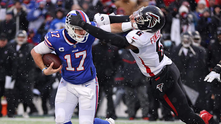 Bills quarterback Josh Allen fights off a tackle by Falcons Donte Fowler Jr. Bills quarterback Josh Allen fights off a tackle by Falcons Donte Fowler Jr.