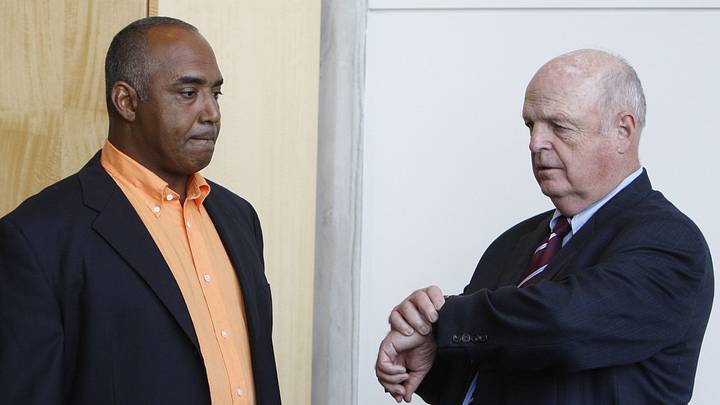 NFL BENGALS. SPORTS.  JULY 26, 2011.Cincinnati Bengals' President Mike Brown, right, checks his watch as he and head coach, Marvin Lewis, left, wait for the start of a press conference to discuss how the team will move forward following the settlement of a labor dispute between NFL owners and players at Paul Brown Stadium Tuesday July 26, 2011.The Enquirer/ Gary Landers