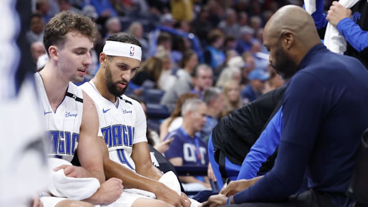 Orlando Magic guard Jalen Suggs (4) and forward Franz Wagner (22) listen to head coach Jamahl Mosley during a time out against the Oklahoma City Thunder in the second half at Paycom Center. 