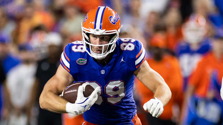 Florida Gators tight end Hayden Hansen (89) runs with the ball after a catch as Samford Bulldogs linebacker Jaden Mosley (33) defends during the first half at Ben Hill Griffin Stadium. 
