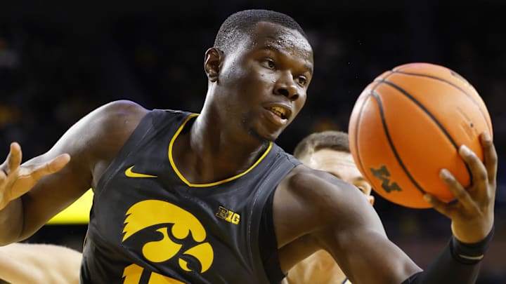 Dec 7, 2024; Ann Arbor, Michigan, USA;  Iowa Hawkeyes forward Ladji Dembele (13) grabs the rebound in the first half against the Michigan Wolverines at Crisler Center. Mandatory Credit: Rick Osentoski-Imagn Images