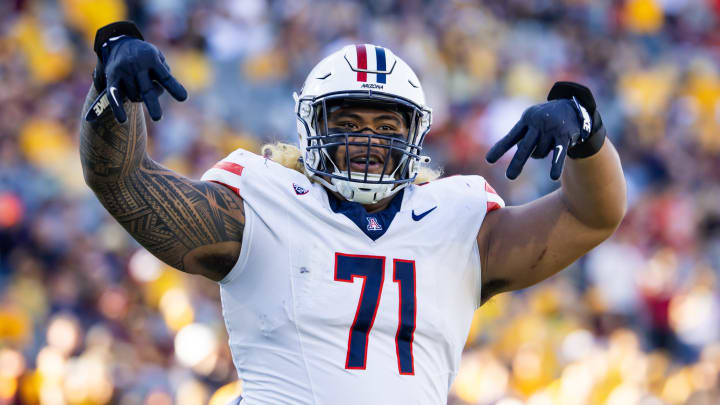 Nov 25, 2023; Tempe, Arizona, USA; Arizona Wildcats offensive lineman Jonah Savaiinaea (71) celebrates a touchdown against the Arizona State Sun Devils in the second half of the Territorial Cup at Mountain America Stadium. Mandatory Credit: Mark J. Rebilas-USA TODAY Sports Nov 25, 2023; Tempe, Arizona, USA; Arizona Wildcats offensive lineman Jonah Savaiinaea (71) celebrates a touchdown against the Arizona State Sun Devils in the second half of the Territorial Cup at Mountain America Stadium. Mandatory Credit: Mark J. Rebilas-USA TODAY Sports