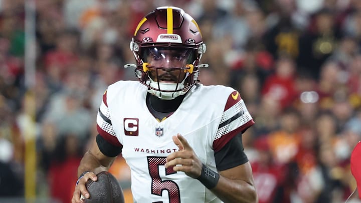 Washington Commanders quarterback Jayden Daniels (5) scrambles during the first quarter of a NFC wild card playoff against the Tampa Bay Buccaneers at Raymond James Stadium. Mandatory Credit: Kim Klement Neitzel-Imagn Images