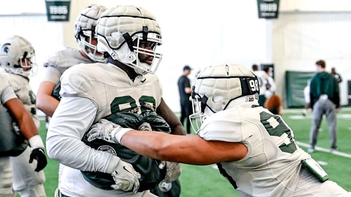 Michigan State's Derrick Simmons, right, and Quindarius Dunnigan work out with the defensive line during football practice on Tuesday, April 8, 2025, in East Lansing.