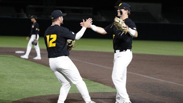 March 24, 2026; O’Fallon, Missouri; Missouri baseball’s Keegan Knutson (left, 12) high fives Jase Wiota (25, right) during a game against Illinois.