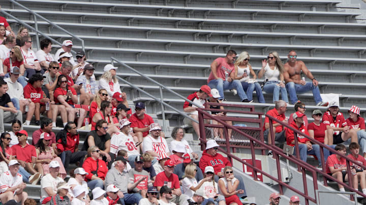 Spectators sits amongst empty seats during the first quarter of the Wisconsin - Maryland football game Saturday, September 20, 2025 at Camp Randall Stadium in Madison, Wisconsin.