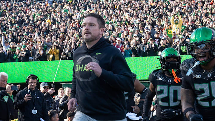 Oregon coach Dan Lanning leads his team onto the field for their game against Southern California Nov. 22, 2025.