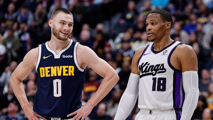 Nov 3, 2025; Denver, Colorado, USA; Denver Nuggets guard Christian Braun (0) and Sacramento Kings guard Russell Westbrook (18) in the first quarter at Ball Arena.