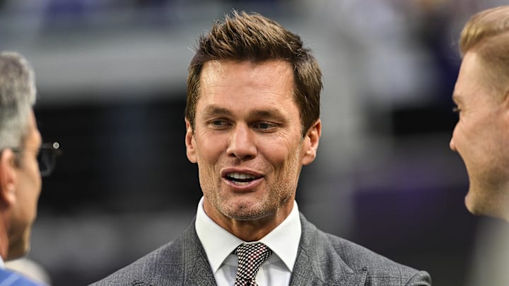 Dec 29, 2024; Minneapolis, Minnesota, USA;  FOX broadcaster and former NFL quarterback Tom Brady looks on before the game between the Minnesota Vikings and the Green Bay Packers at U.S. Bank Stadium. Mandatory Credit: Jeffrey Becker-Imagn Images