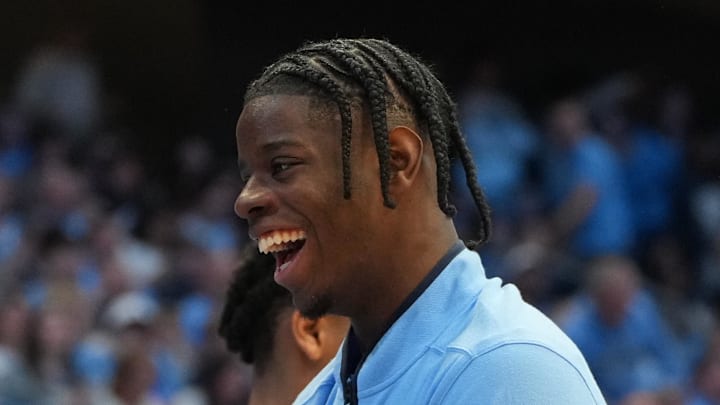 Feb 14, 2026; Chapel Hill, North Carolina, USA; North Carolina Tar Heels guard Isaiah Denis (5) and forward Caleb Wilson (8) react on the bench in the second half at Dean E. Smith Center. Mandatory Credit: Bob Donnan-Imagn Images