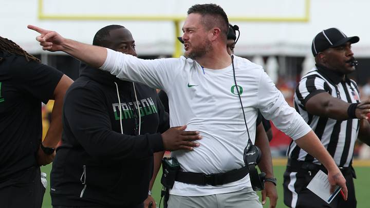 Sep 26, 2026; Los Angeles, California, USA;  Oregon Ducks head coach Dan Lanning points toward the USC Trojans sideline after quarterback Dante Moore (not pictured) was injured on a tackle and targeting penalty against USC Trojans linebacker Desman Stephens II (not pictured) during the second quarter at United Airlines Field at Los Angeles Memorial Coliseum.  Mandatory Credit: Kiyoshi Mio-Imagn Images