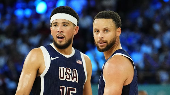 United States guards Devin Booker and Stephen Curry react in the second half against France in the men's basketball gold medal game during the Paris 2024 Olympic Summer Games at Accor Arena.