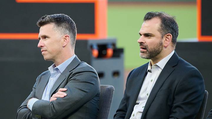 San Francisco, California, USA; San Francisco Giants president of baseball operations Buster Posey (center) and general manager Zack Minasian look on during a ceremony honoring MLB Hall of Fame member and former Giants player Jeff Kent (not pictured) at Oracle Park.  Mandatory Credit: Robert Edwards-Imagn Images