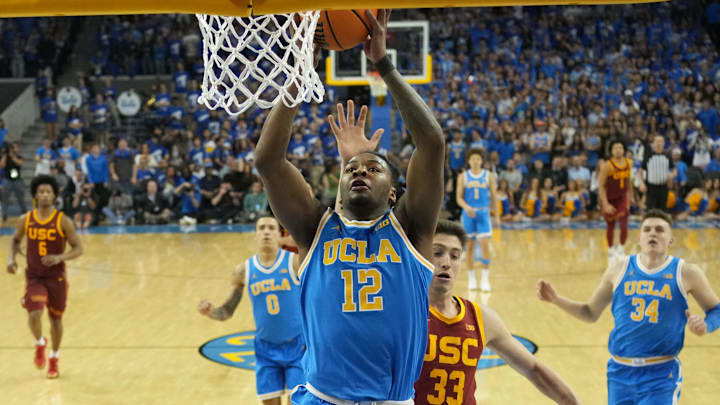Mar 8, 2025; Los Angeles, California, USA; UCLA Bruins guard Sebastian Mack (12) dunks the ball against Southern California Trojans forward Josh Cohen (33) in the second half at Pauley Pavilion presented by Wescom. Mandatory Credit: Kirby Lee-Imagn Images