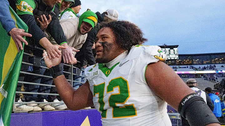 Oregon offensive lineman Iapani Laloulu celebrates with fans as the Oregon Ducks take on the Washington Huskies on Nov. 29, 2025, at Husky Stadium in Seattle, Washington.