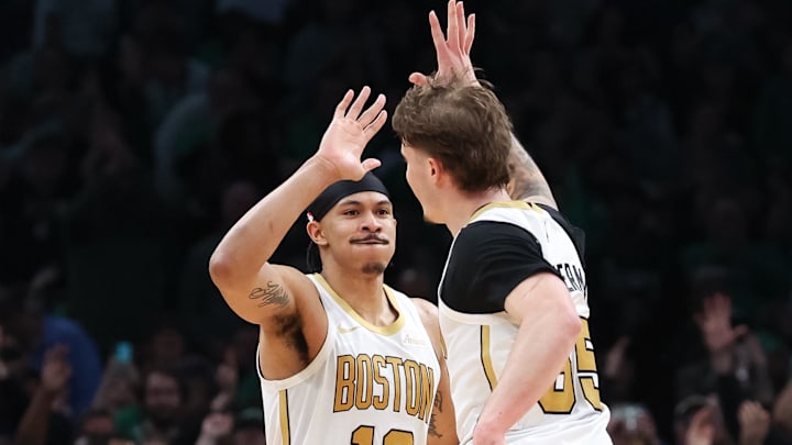 Apr 12, 2026; Boston, Massachusetts, USA; Boston Celtics forward Ron Harper Jr (13) and Boston Celtics guard Baylor Scheierman (55) celebrate during the second half against the Orlando Magic at TD Garden. Mandatory Credit: Paul Rutherford-Imagn Images