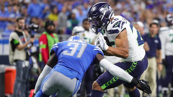 Detroit Lions safety Kerby Joseph (31) tackles Seattle Seahawks running back Zach Charbonnet (26) 