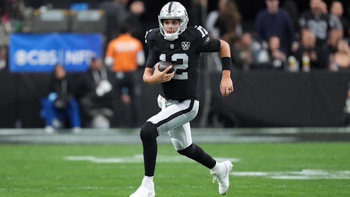 Dec 22, 2024; Paradise, Nevada, USA; Las Vegas Raiders quarterback Aidan O'Connell (12) runs against the Jacksonville Jaguars in the first half at Allegiant Stadium. Mandatory Credit: Kirby Lee-Imagn Images