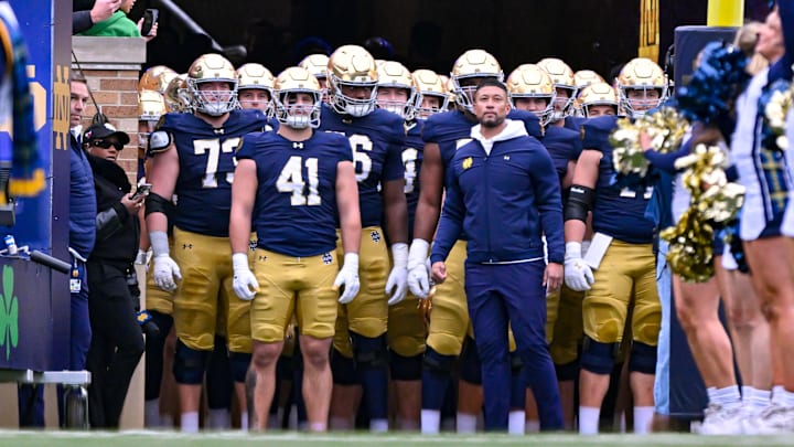 Nov 16, 2024; South Bend, Indiana, USA; Notre Dame Fighting Irish head coach Marcus Freeman prepares to lead his players onto the field for the game against the Virginia Cavaliers at Notre Dame Stadium. Nov 16, 2024; South Bend, Indiana, USA; Notre Dame Fighting Irish head coach Marcus Freeman prepares to lead his players onto the field for the game against the Virginia Cavaliers at Notre Dame Stadium.