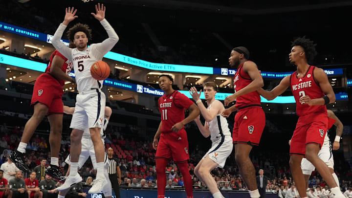 Mar 12, 2026; Charlotte, NC, USA; Virginia Cavaliers guard Sam Lewis (5) watches the ball against the NC State Wolfpack during the first half at Spectrum Center. Mandatory Credit: Jim Dedmon-Imagn Images