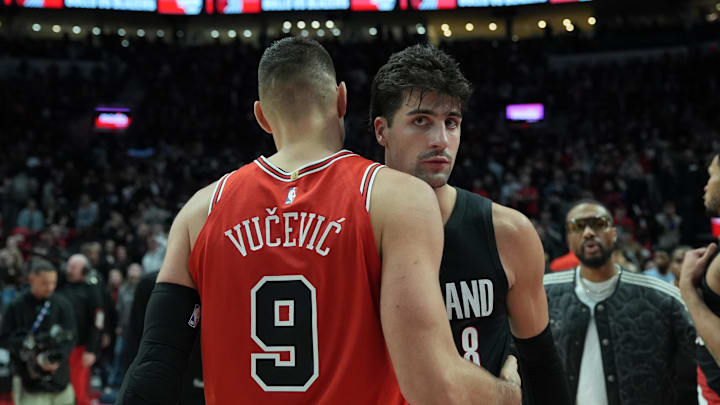 Nov 19, 2025; Portland, Oregon, USA; Chicago Bulls center Nikola Vucevic (9) and Portland Trail Blazers forward Deni Avdija (8) meet after the game at Moda Center. Mandatory Credit: Soobum Im-Imagn Images