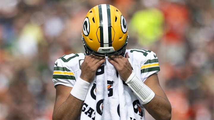 Green Bay Packers quarterback Jordan Love (10) wipes his face during a timeout against the Cleveland Browns.