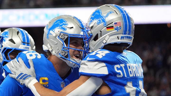 Detroit Lions quarterback Jared Goff (16) celebrates the touchdown with Detroit Lions wide receiver Amon-Ra St. Brown (14) during the first half of the NFL game at Ford Field in Detroit, Sunday, Sept. 27, 2026.