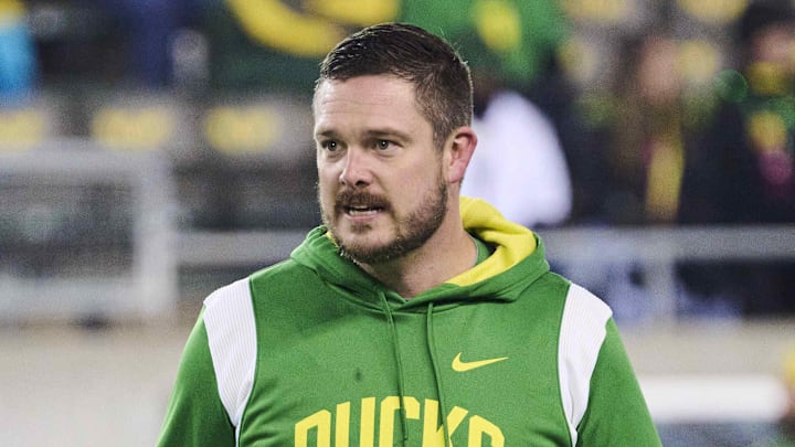 Nov 19, 2022; Eugene, Oregon, USA; Oregon Ducks head coach Dan Lanning watches players warm up before a game against the Utah Utes at Autzen Stadium. Mandatory Credit: Troy Wayrynen-Imagn Images