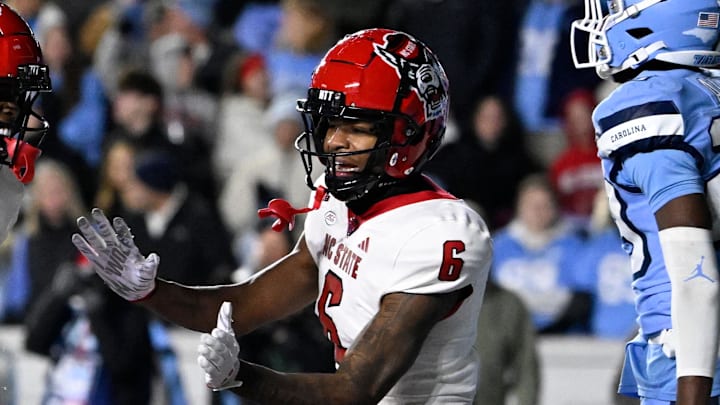 Nov 30, 2024; Chapel Hill, North Carolina, USA; North Carolina State Wolfpack running back Hollywood Smothers (20) reacts with wide receiver Wesley Grimes (6) after scoring a touchdown with 25 seconds to go in the fourth quarter at Kenan Memorial Stadium. Mandatory Credit: Bob Donnan-Imagn Images