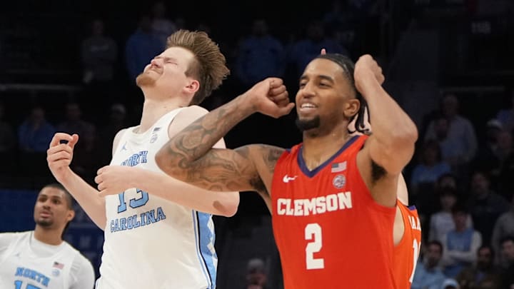 Mar 12, 2026; Charlotte, NC, USA; North Carolina Tar Heels center Henri Veesaar (13) rand Clemson Tigers guard Dillon Hunter (2) react at the end of the game at Spectrum Center. Mandatory Credit: Bob Donnan-Imagn Images