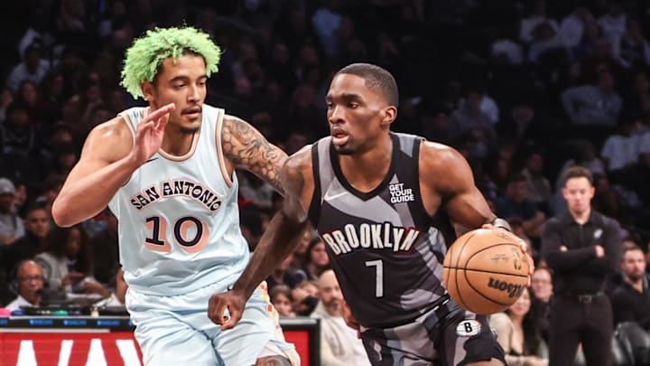 Dec 27, 2024; Brooklyn, New York, USA;  Brooklyn Nets guard Shake Milton (7) drives past San Antonio Spurs forward Jeremy Sochan (10) in the third quarter at Barclays Center. Mandatory Credit: Wendell Cruz-Imagn Images