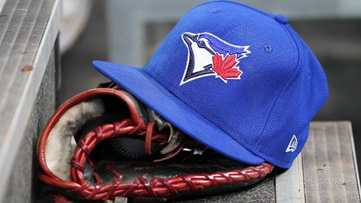 Apr 16, 2025; Toronto, Ontario, CAN; A Toronto Blue Jays hat and glove in the dugout during a game against the Atlanta Braves at Rogers Centre. 