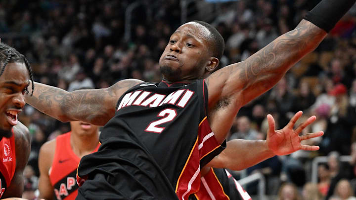 Dec 1, 2024; Toronto, Ontario, CAN;  Toronto Raptors guard Davion Mitchell (45) drives toward the basket against Miami Heat guard Terry Rozier III (2) in the second half at Scotiabank Arena. Mandatory Credit: Dan Hamilton-Imagn Images