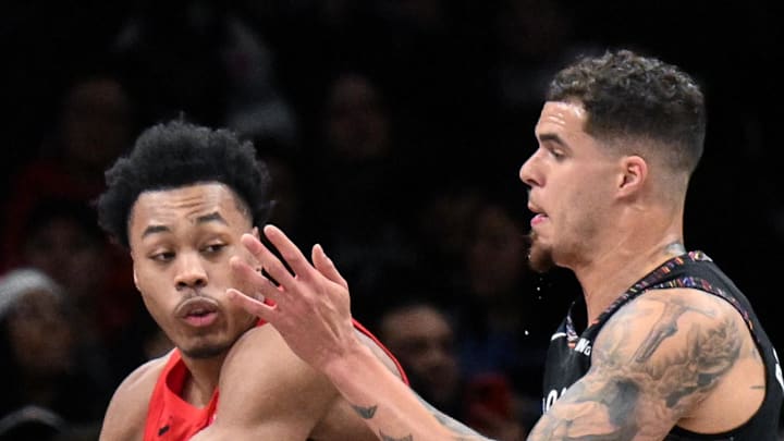 Toronto Raptors forward/guard Scottie Barnes looks to pass the ball as Brooklyn Nets forward Michael Porter Jr.