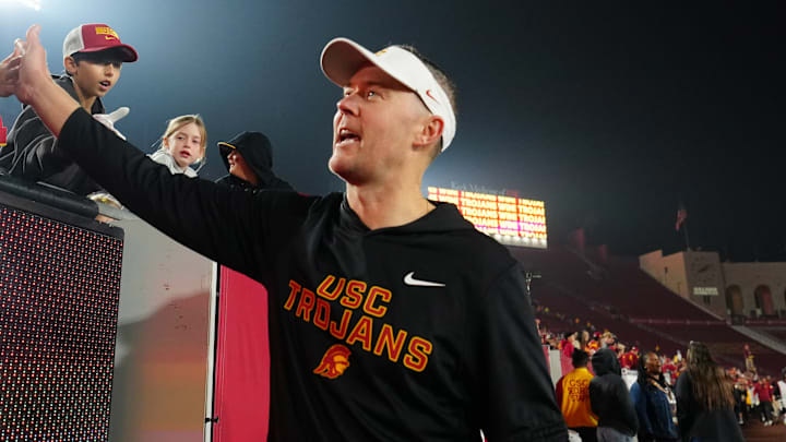 Southern California Trojans head coach Lincoln Riley celebrates with fans after the game against the UCLA Bruins at United Airlines Field at Los Angeles Memorial Coliseum.