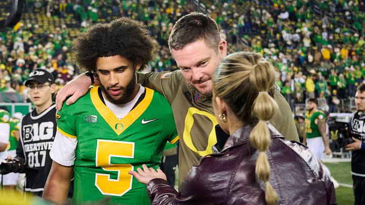 Nov 14, 2025; Eugene, Oregon, USA; Oregon Ducks quarterback Dante Moore (5) and head coach Dan Lanning talk to a reporter after a game against the Minnesota Golden Gophers at Autzen Stadium. Mandatory Credit: Troy Wayrynen-Imagn Images