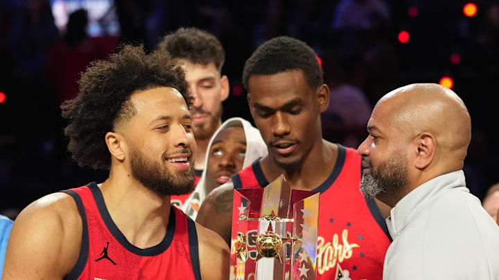 Team USA Stars guard Cade Cunningham (2) of the Detroit Pistons and head coach J. B. Bickerstaff lift the trophy during the 75th NBA All Star Game at Intuit Dome on Feb 15, 2026.