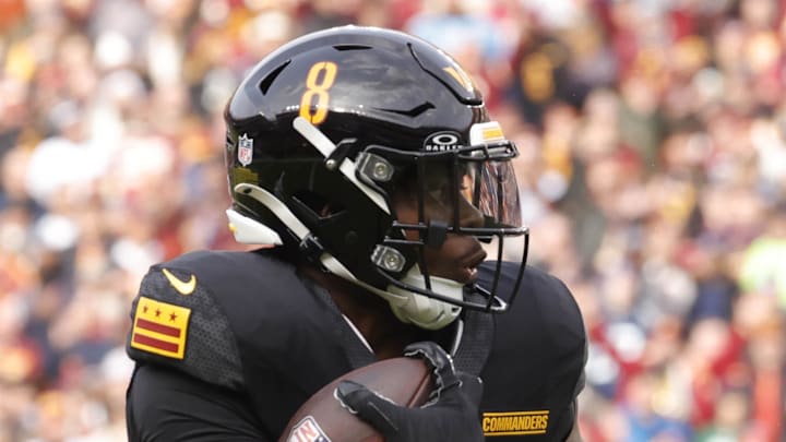 Washington Commanders running back Brian Robinson Jr. carries the ball to score a touchdown.