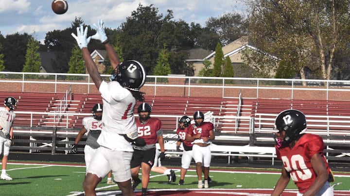 Ballard High School receiver Malachi Allen leaps for a ball Tuesday, Oct. 21, at a Bruin practice. Ballard just might have the most challenging regular-season schedule in the state.