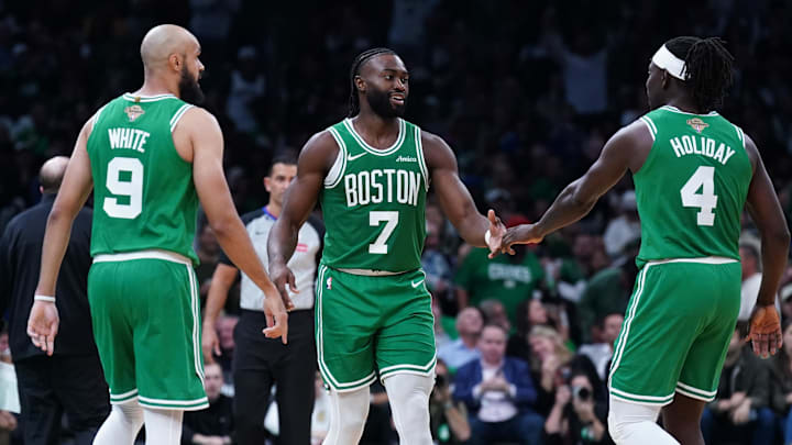 Oct 22, 2024; Boston, Massachusetts, USA; Boston Celtics guard Jaylen Brown (7), guard Jrue Holiday (4) and guard Derrick White (9) react after a play against the New York Knicks in the second half at TD Garden. Mandatory Credit: David Butler II-Imagn Images