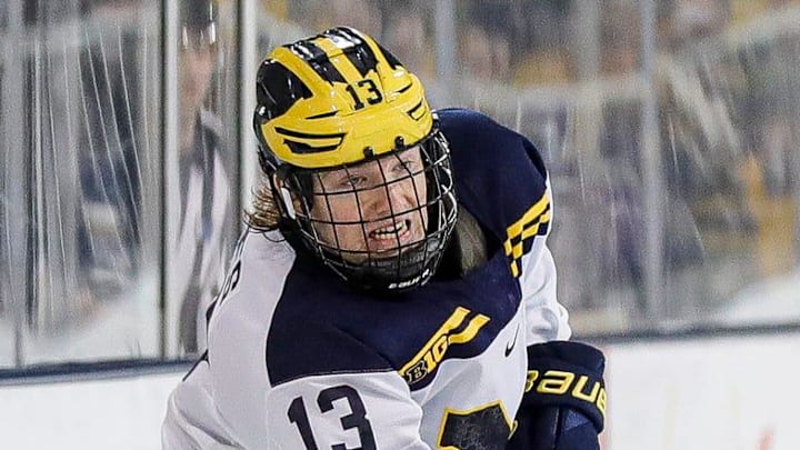 Michigan center TJ Hughes makes a pass against Michigan State defenseman Nash Nienhuis during the third period at Yost Ice Arena in Ann Arbor on Friday, Feb. 9, 2024.