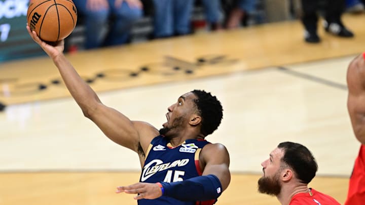 Apr 20, 2026; Cleveland, Ohio, USA; Cleveland Cavaliers guard Donovan Mitchell (45) goes to the basket against Toronto Raptors forward Sandro Mamukelashvili (54) during the second half during game two of the first round of the 2026 NBA Playoffs at Rocket Arena. Mandatory Credit: David Dermer-Imagn Images