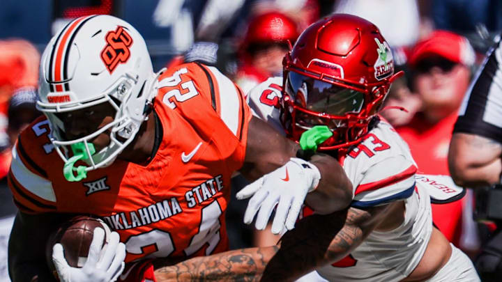 Oct 4, 2025; Tucson, Arizona, USA; Arizona Wildcats defensive back Dalton Johnson (43) tackles Oklahoma State Cowboys running back Trent Howland (24) during the second quarter at Arizona Stadium. Mandatory Credit: Aryanna Frank-Imagn Images