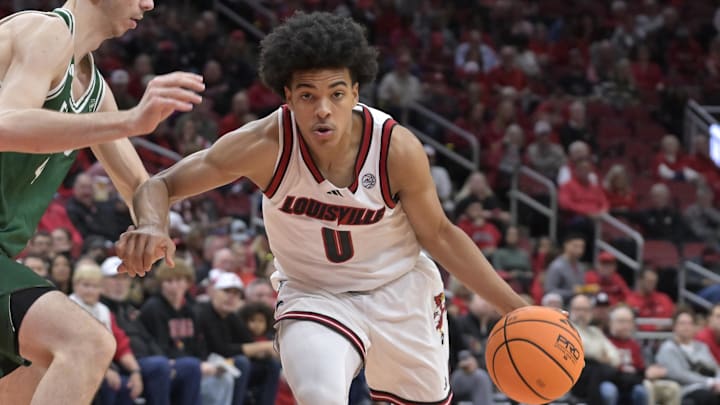 Nov 24, 2025; Louisville, Kentucky, USA; Louisville Cardinals guard Mikel Brown Jr. (0) dribbles against Eastern Michigan Eagles forward Mohammad Habhab (4) during the second half at KFC Yum! Center. Louisville defeated Eastern Michigan 87-46. Mandatory Credit: Jamie Rhodes-Imagn Images
