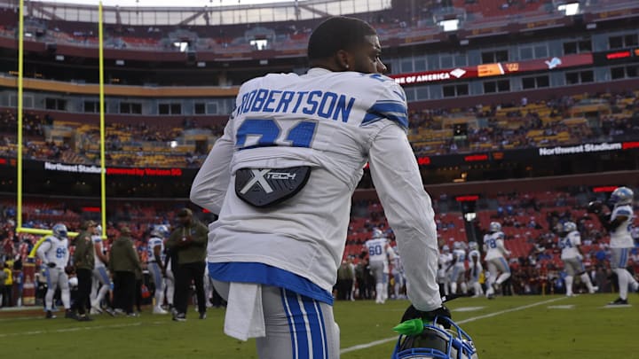 Detroit Lions cornerback Amik Robertson (21) kneels on the field during warmups prior to a game against Commanders