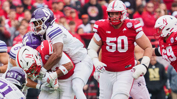 Nebraska guard Rocco Spindler (50) watches running back Isaiah Mozee gain yards against Northwestern.