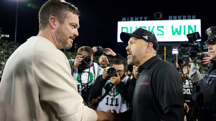 The head coaches shake hands after the Ducks' victory Saturday night.