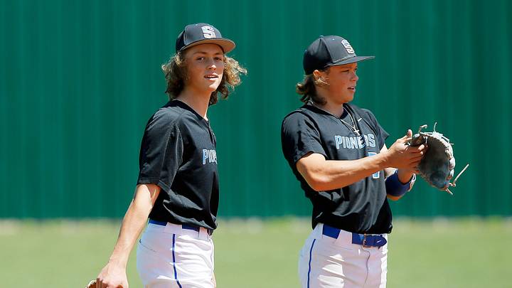 Ethan Holliday, left, and Jackson Holliday stand during a Stillwater High School baseball game on April 30, 2022.